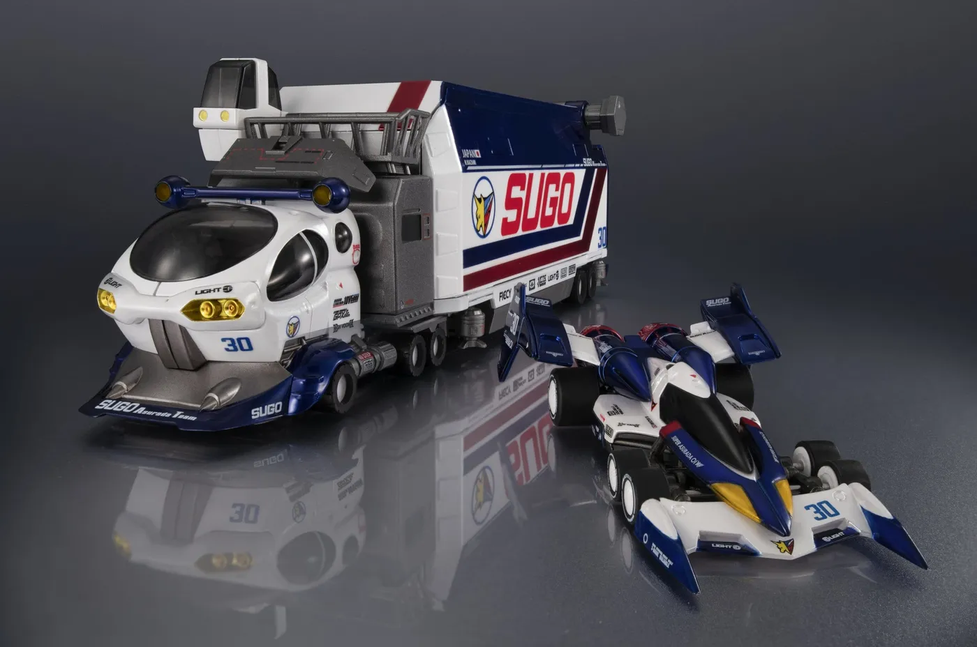 Heritage Edition Sugo Legard 10V5000 transporter in white and blue beside the Super Asurada 01 in Circuit Mode