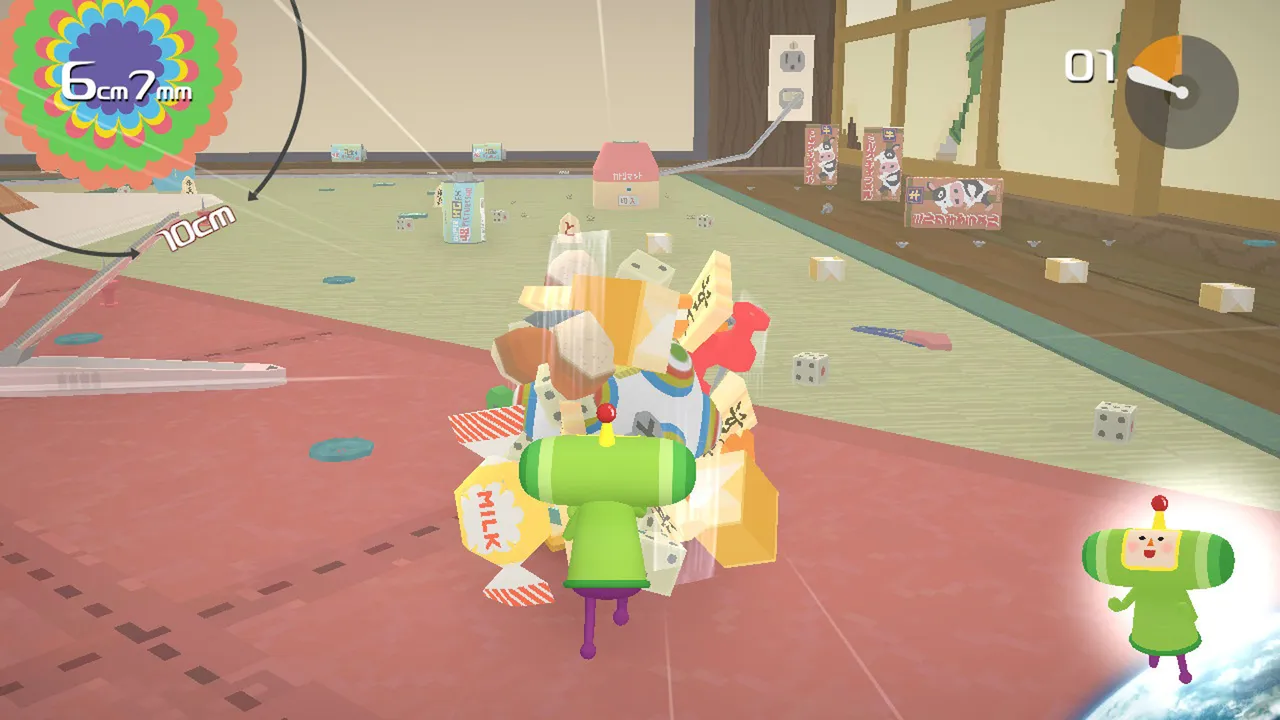 The Prince rolls a small katamari of sweets and dice across a floor