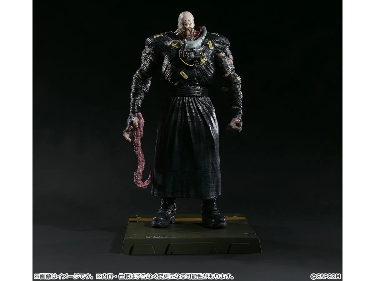 Capcom Figure Builder Creator's Model Nemesis statue in a black coat with the tentacle arm fitted, standing on a green transport case base